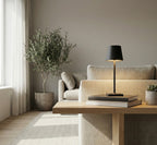 Modern living room with a beige sofa, wooden coffee table, and decorative items.